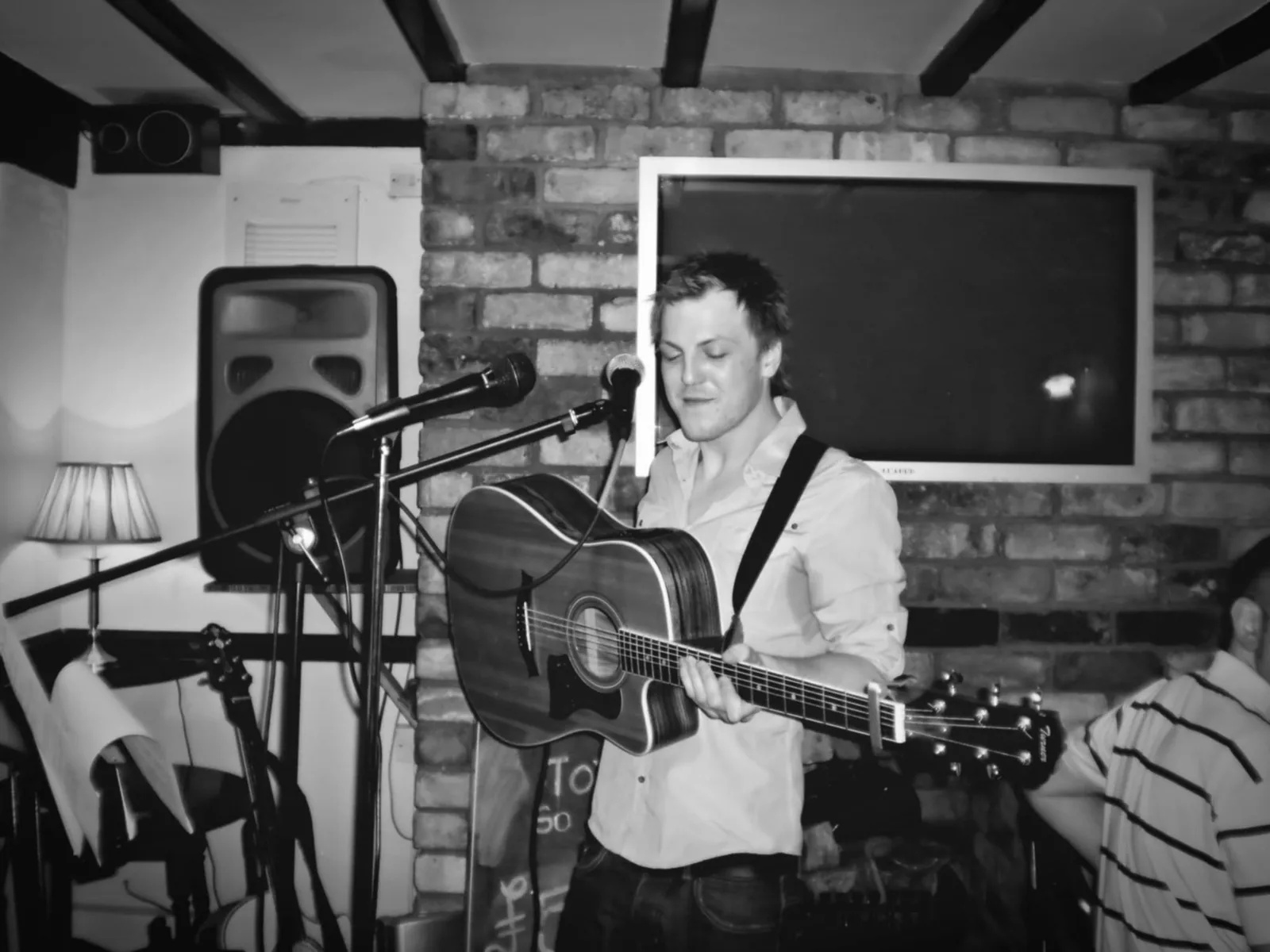 Mitchell playing an acoustic set in a pub